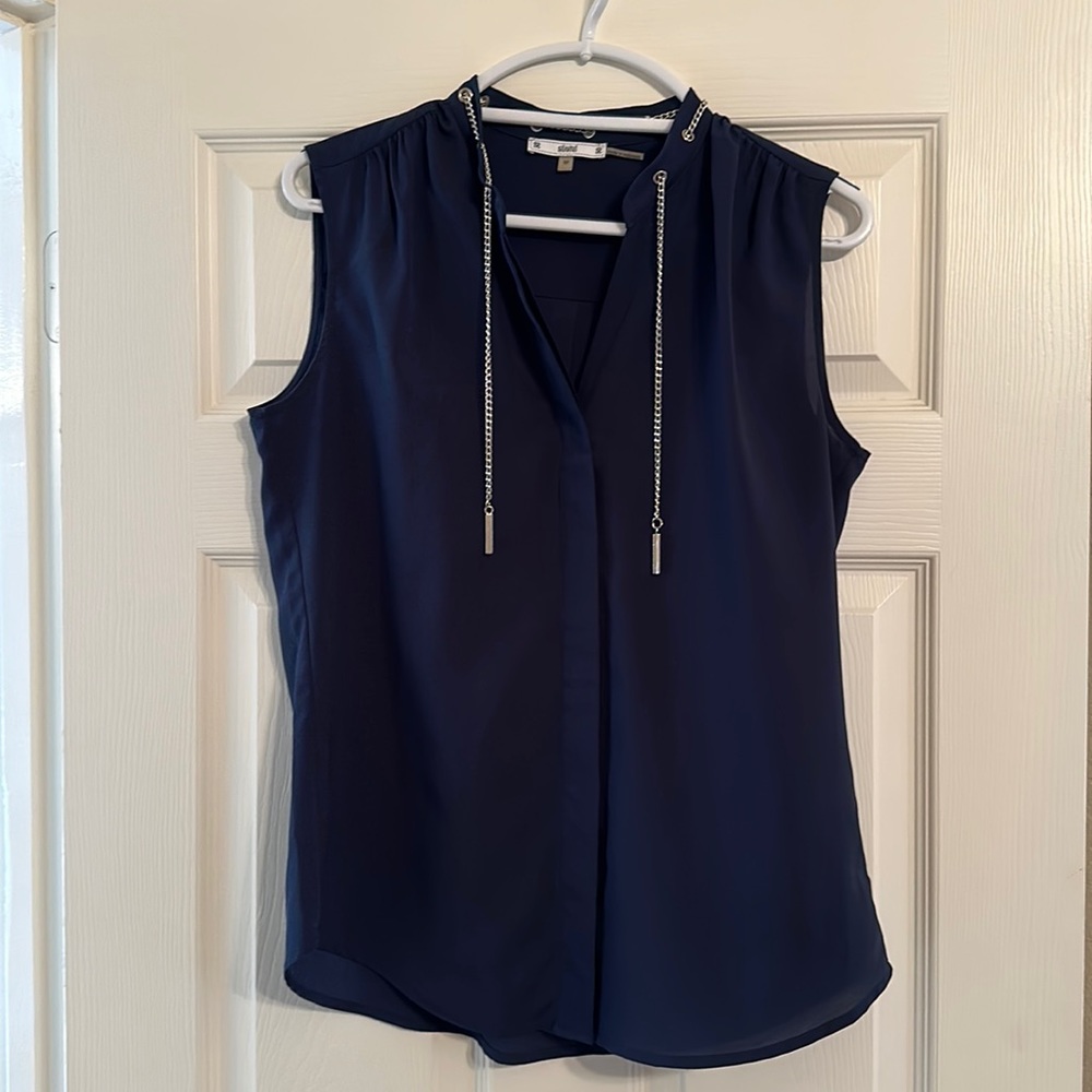 Navy blue. Only worn a few times. Hidden buttons down front. Machine washable.